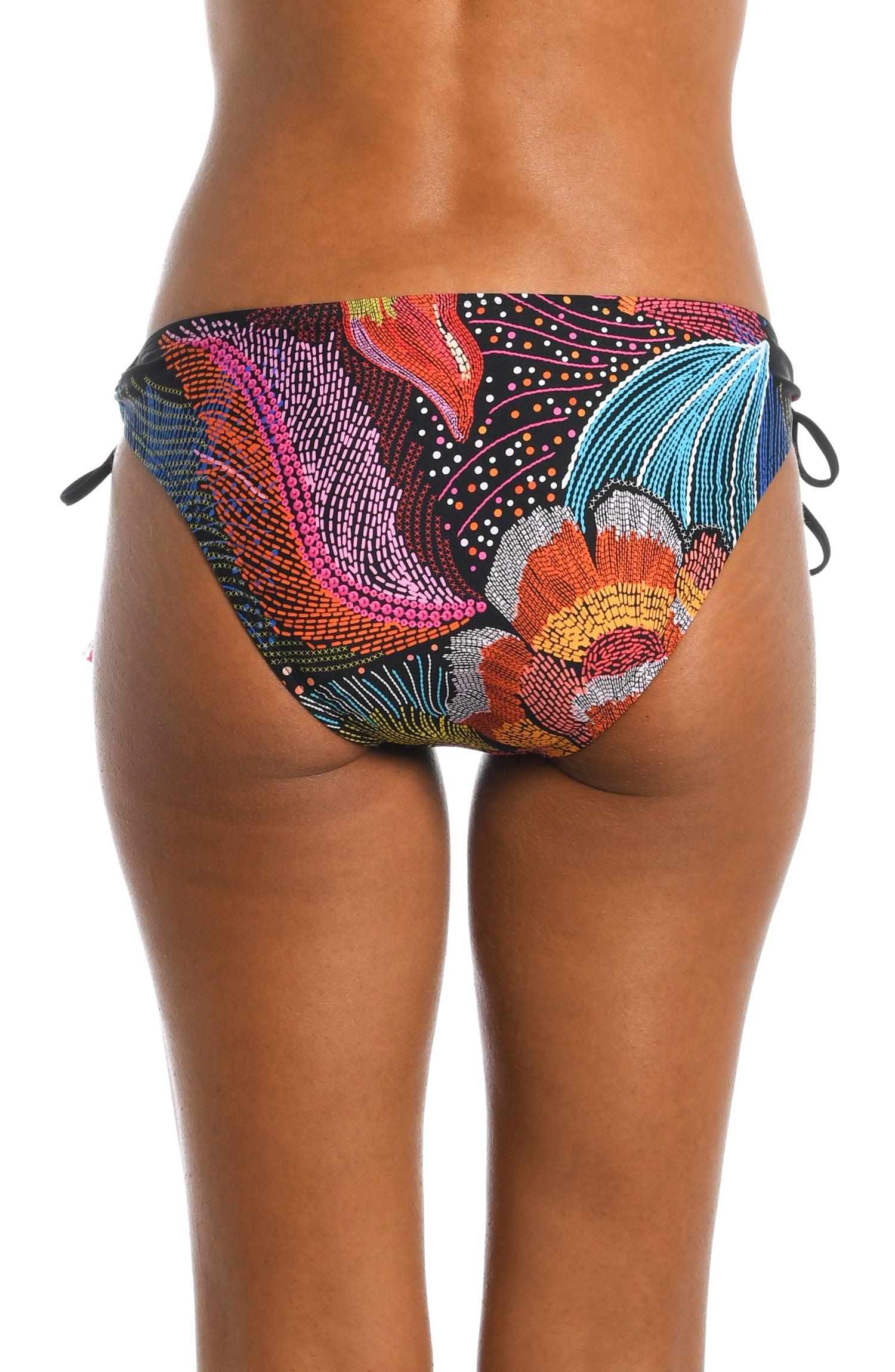 Model is wearing a shiny multicolored tropical printed side tie hipster bottom from our Sunlit Soriee collection!