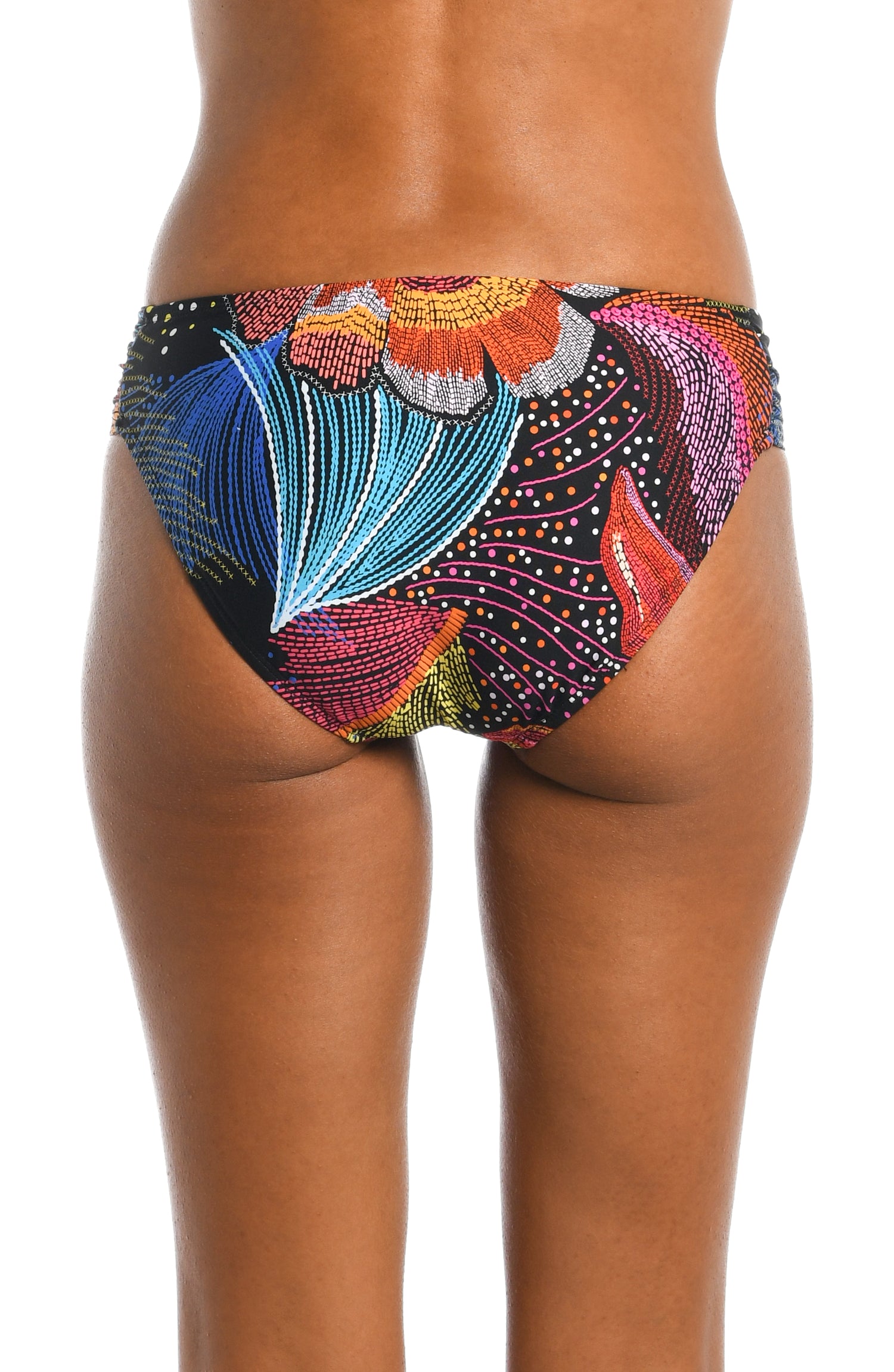 Model is wearing a shiny multicolored tropical printed side shirred hipster bottom from our Sunlit Soriee collection!