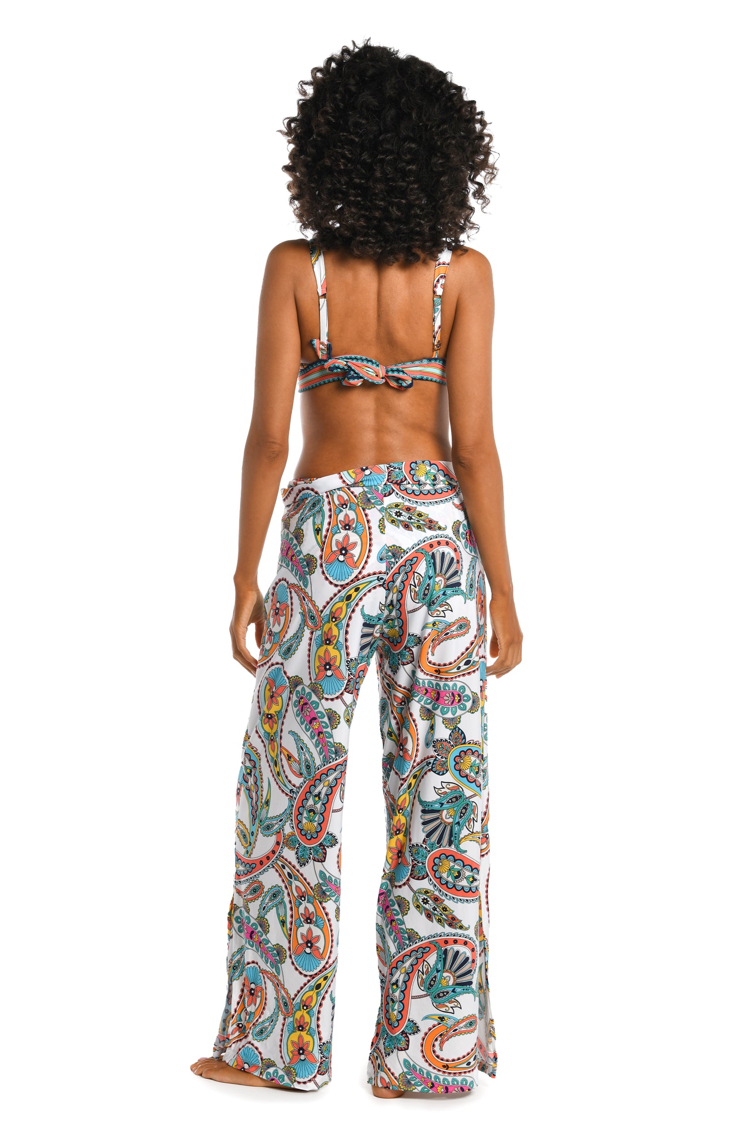 Model is wearing a multi colored paisley printed cover up pants from our Pave the Way collection!