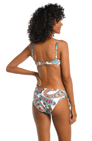 Model is wearing a multi colored paisley printed over the shoulder top from our Pave the Way collection!