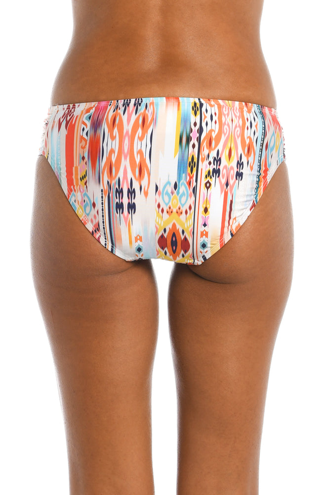 
            
                Load image into Gallery viewer, Model is wearing a multi colored tribal printed side tie hipster bottom from our Desert Dream collection!
            
        