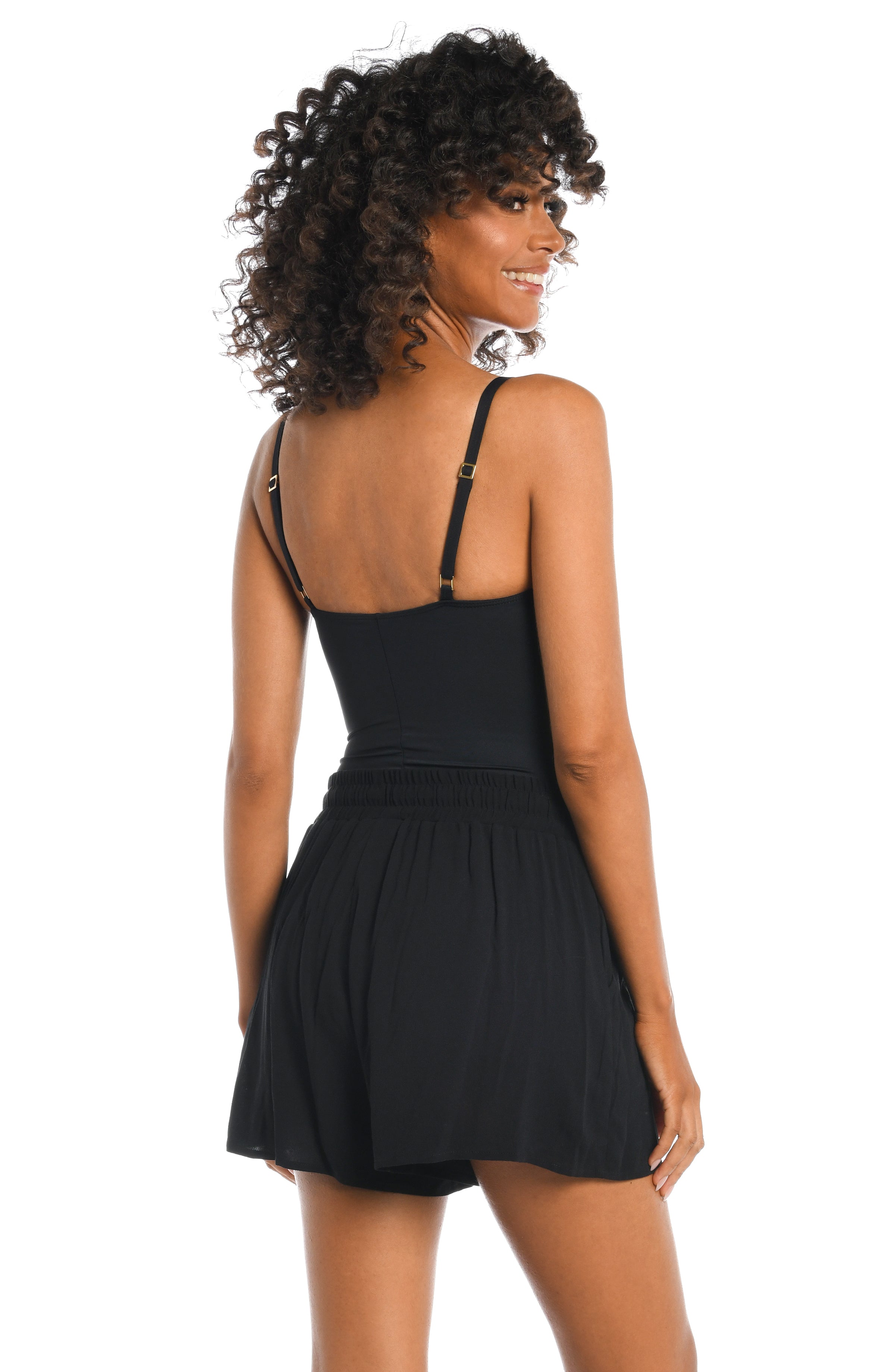 Model is wearing solid black beach shorts cover up from our Beachcomber Basics collection!