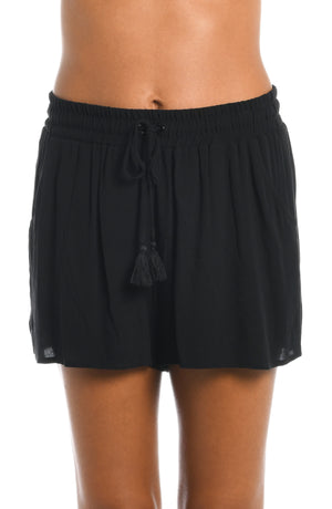 
            
                Load image into Gallery viewer, Model is wearing solid black beach shorts cover up from our Beachcomber Basics collection!
            
        