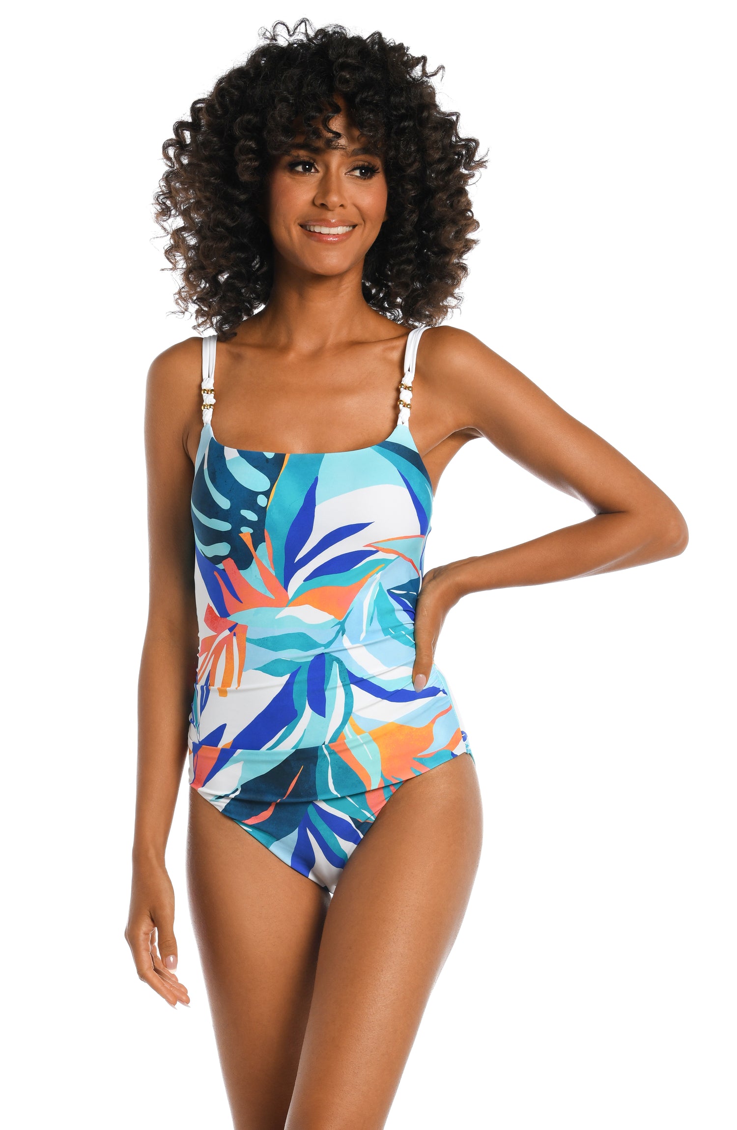 Model is wearing a blue multi colored tropical printed over the shoulder one piece from our Coastal Palms collection!