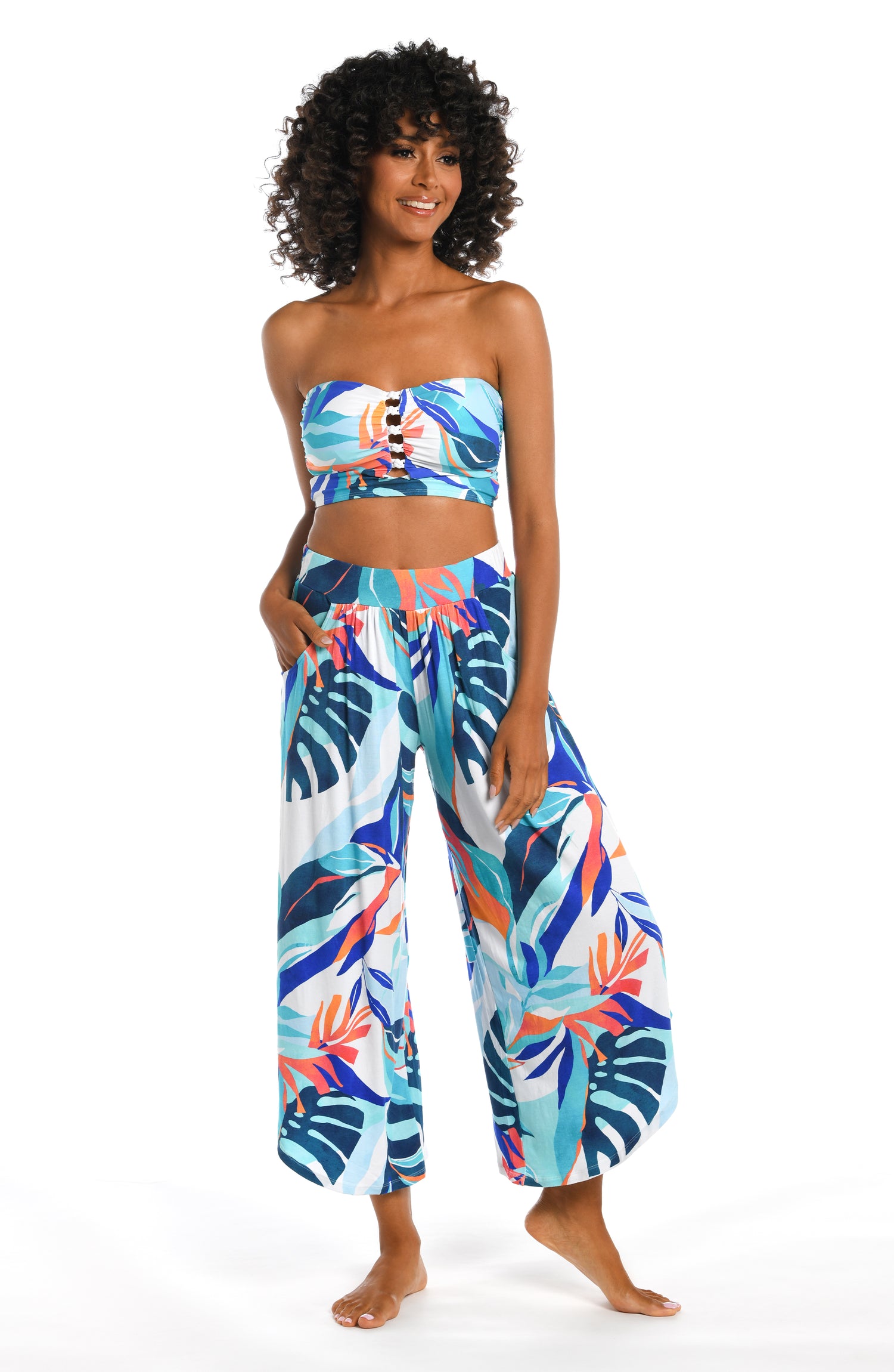 Model is wearing a blue multi colored tropical printed cover up pant from our Coastal Palms collection!