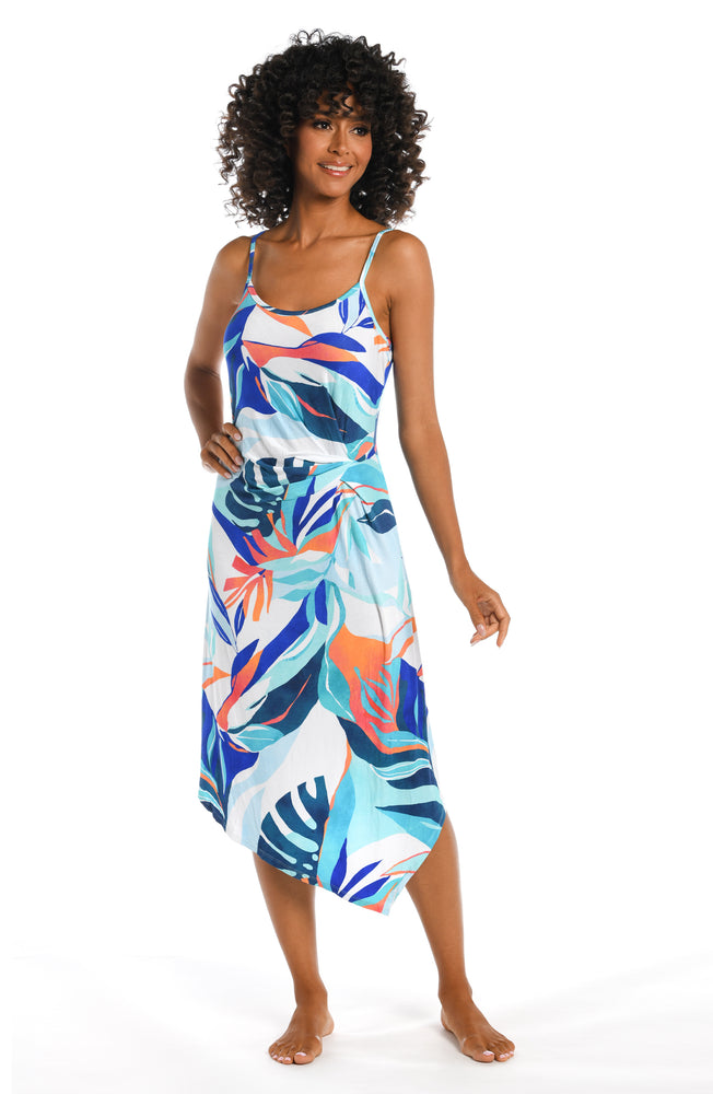 Model is wearing a blue multi colored tropical printed cover up dress from our Coastal Palms collection!