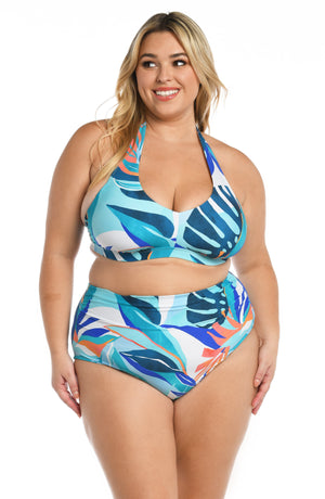 Model is wearing a blue multi colored tropical printed banded halter top from our Coastal Palms collection!