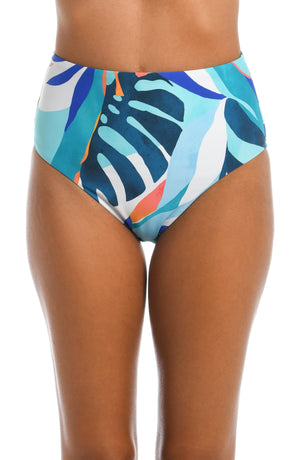 
            
                Load image into Gallery viewer, Model is wearing a blue multi colored tropical printed high waist bottom from our Coastal Palms collection!
            
        
