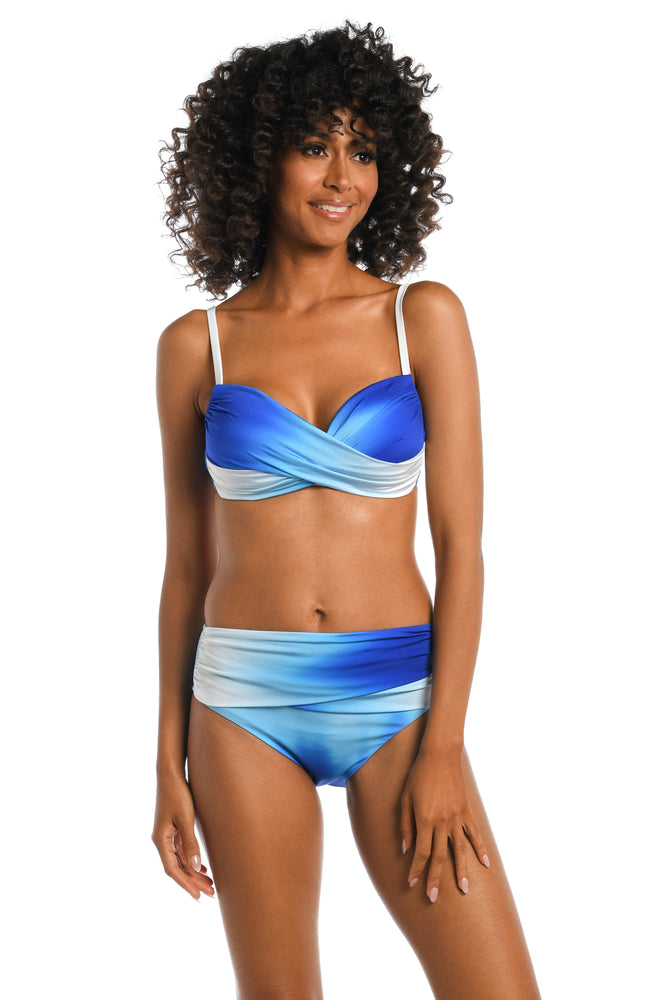 Model is wearing a sapphire colored ombre printed over the shoulder top from our Ocean Oasis collection!