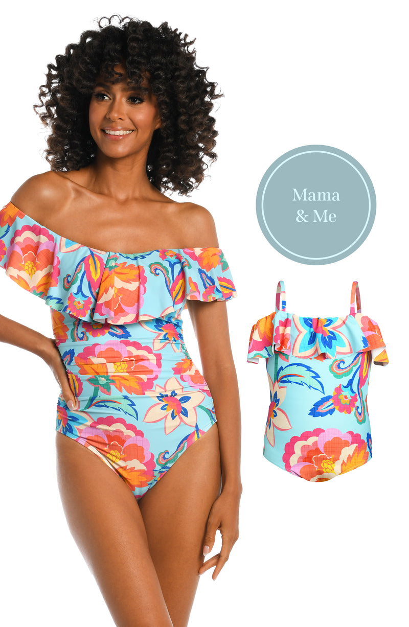 Model is wearing a light blue multi colored tropical printed off shoulder one piece from our Breezy Beauty collection!