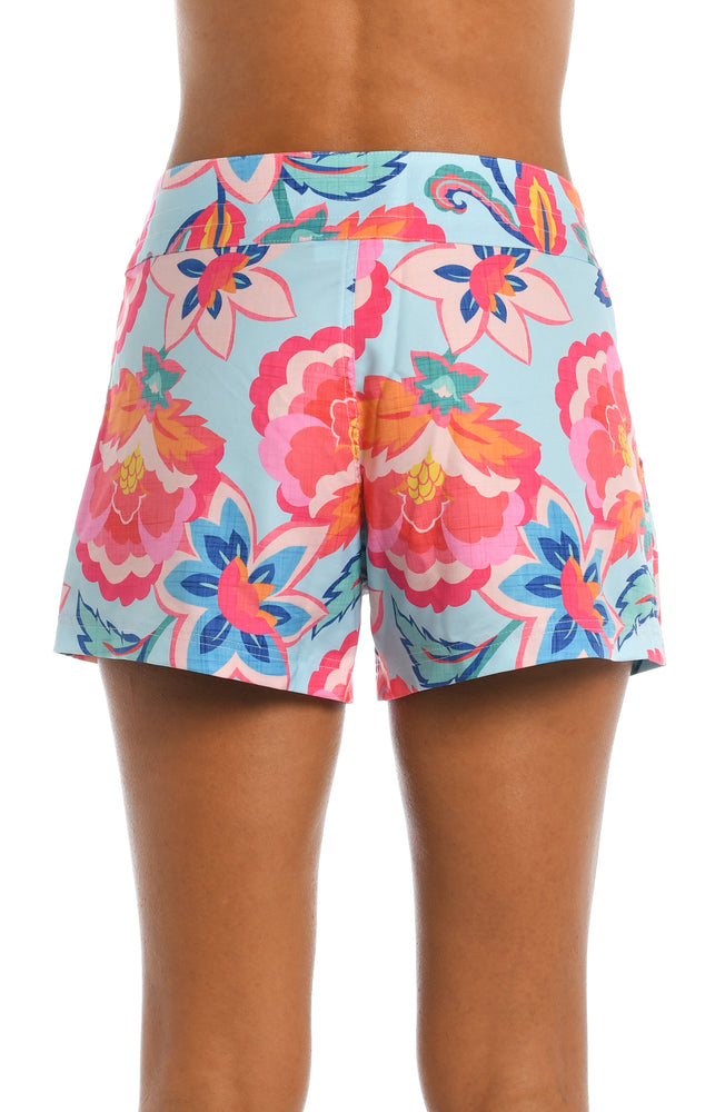 Model is wearing a light blue multi colored tropical printed board short bottom from our Breezy Beauty collection!