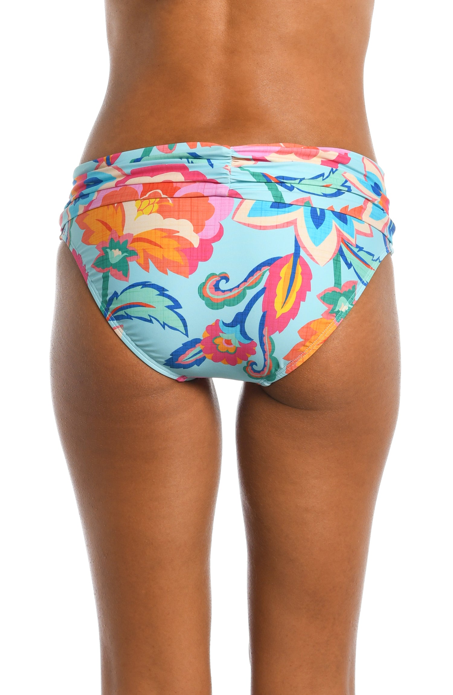 Model is wearing a light blue multi colored tropical printed shirred band hipster bottom from our Breezy Beauty collection!