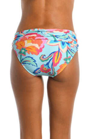 Model is wearing a light blue multi colored tropical printed shirred band hipster bottom from our Breezy Beauty collection!