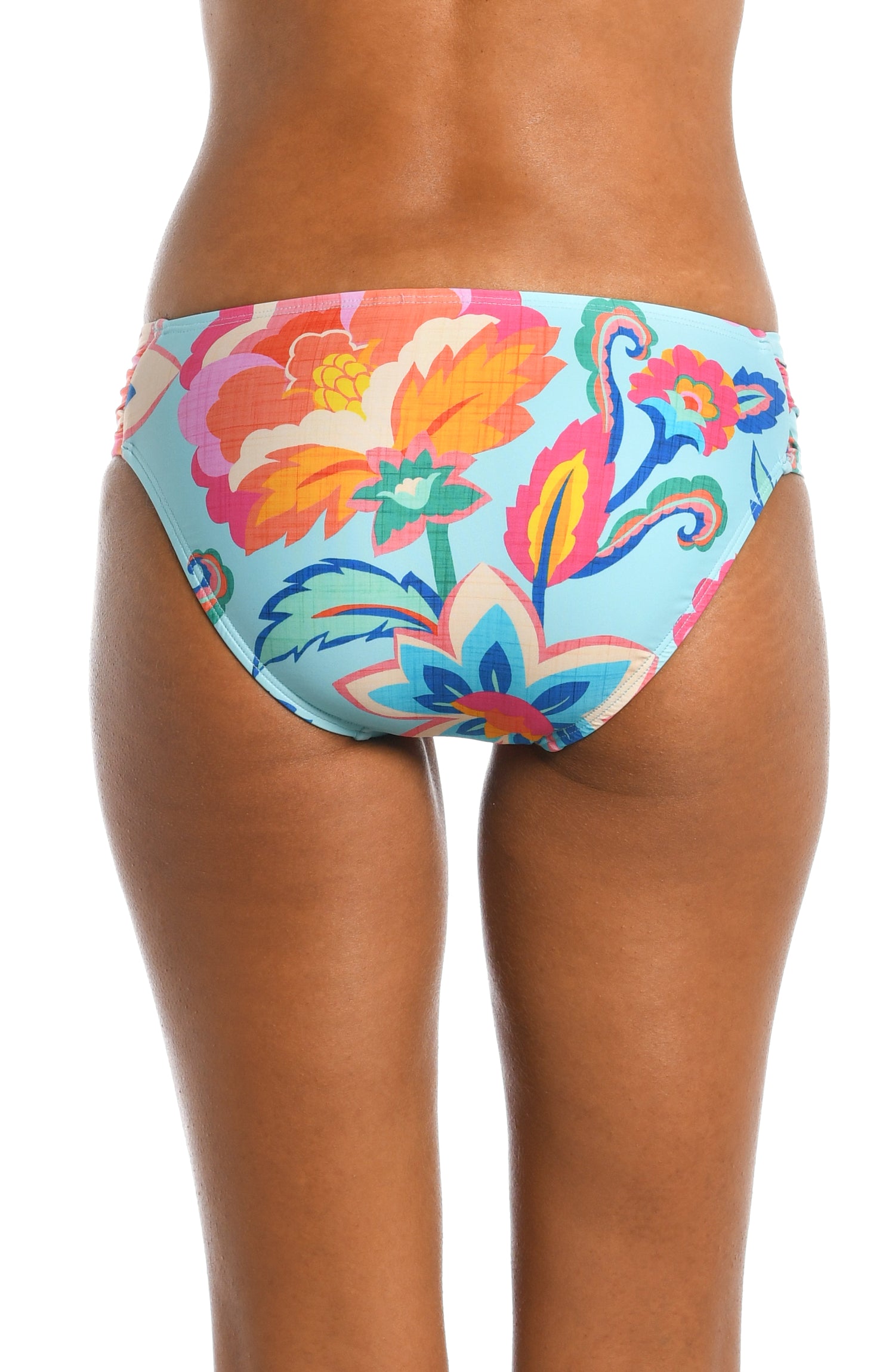 Model is wearing a light blue multi colored tropical printed side shirred hipster bottom from our Breezy Beauty collection!