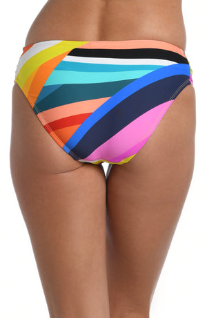 
            
                Load image into Gallery viewer, Model is wearing multi colored vibrant geometric printed side shirred hipster bottom from our Sunscape collection!
            
        