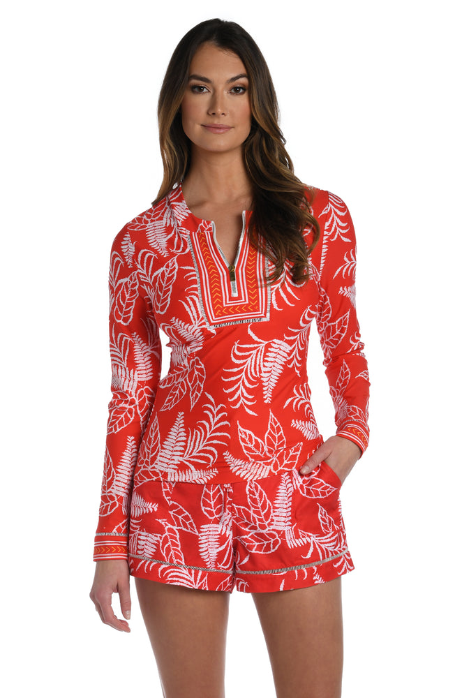 
            
                Load image into Gallery viewer, Model is wearing cherry red tropical printed half zip rashguard top up from our Tropical Tapestry collection!
            
        