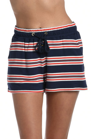
            
                Load image into Gallery viewer, Model is wearing a red, white, and blue striped patterned beach shorts from our Sailor Stripe collection!
            
        