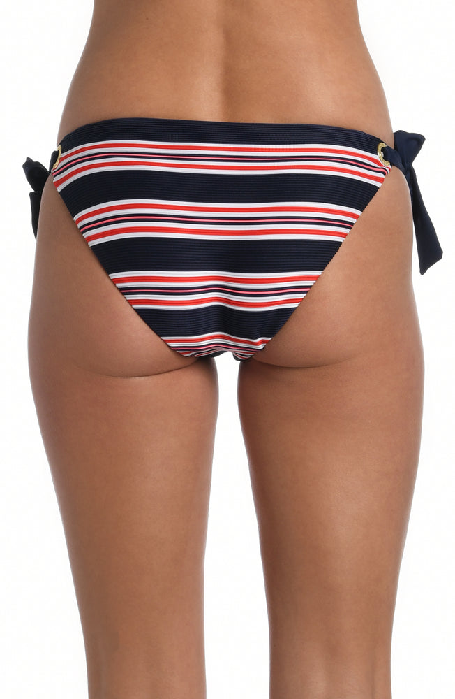 
            
                Load image into Gallery viewer, Model is wearing a red, white, and blue striped patterned side tie hipster bottom from our Sailor Stripe collection!
            
        
