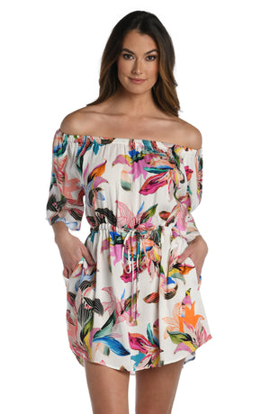 Model is wearing a multi colored tropical printed off the shoulder dress cover up from our Paradise City collection!