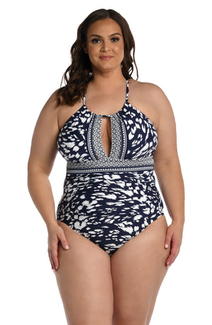 
            
                Load image into Gallery viewer, Model is wearing a indigo blue colored print with pops of white on this high neck keyhole one piece from our Changing Tides collection!
            
        