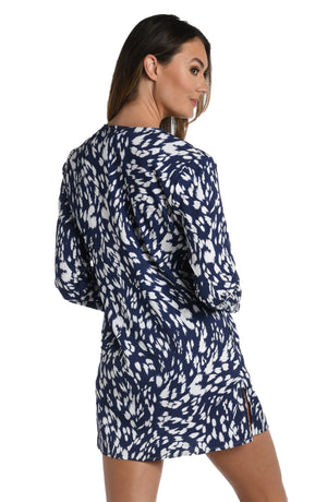 Model is wearing a indigo blue colored print with pops of white on this v-neck tunic cover up from our Changing Tides collection!