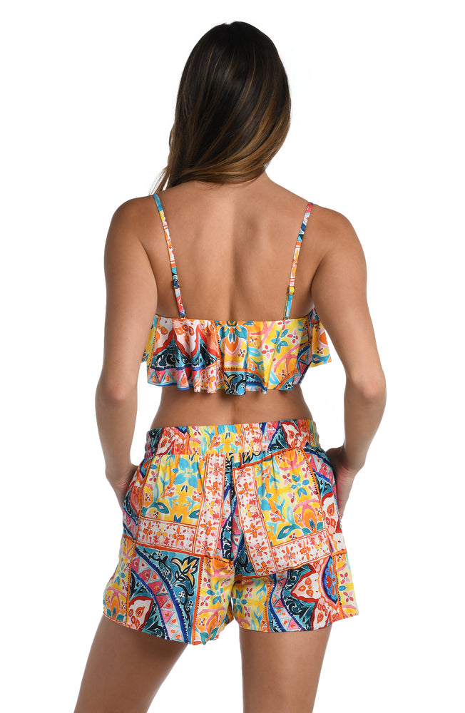 
            
                Load image into Gallery viewer, Model is wearing a moroccan inspired multi colored printed beach shorts cover up from our Soleil collection!
            
        