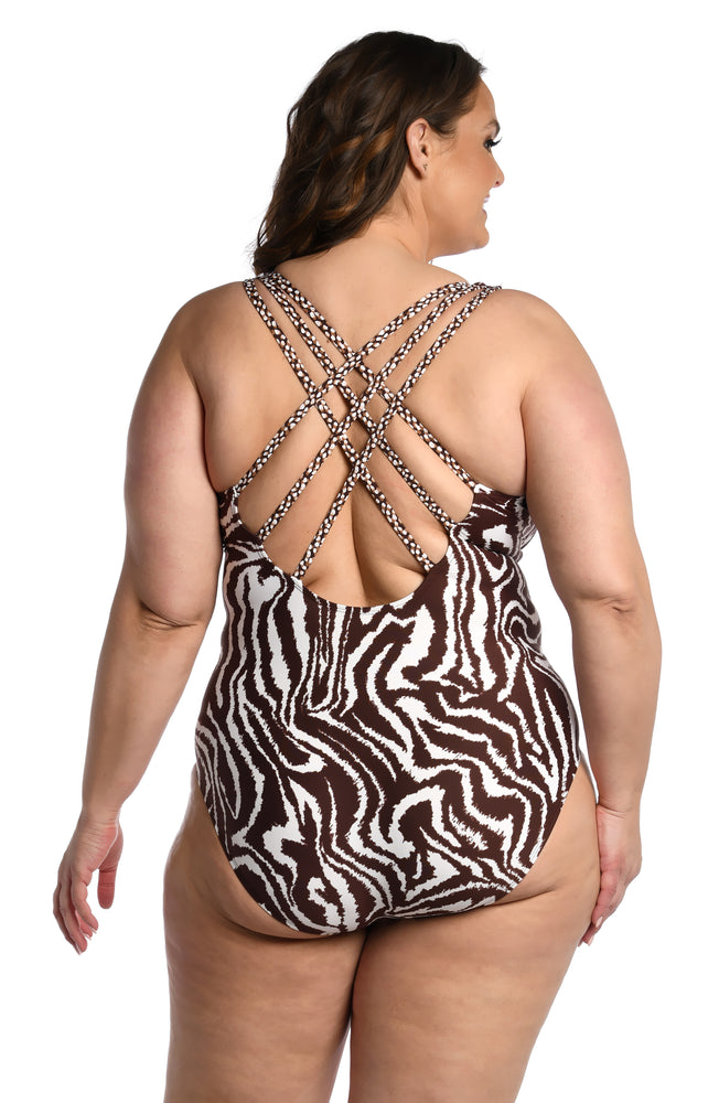 
            
                Load image into Gallery viewer, Model is wearing a java colored animal printed multi-strap crossback one piece in our Fierce Lines collection!
            
        