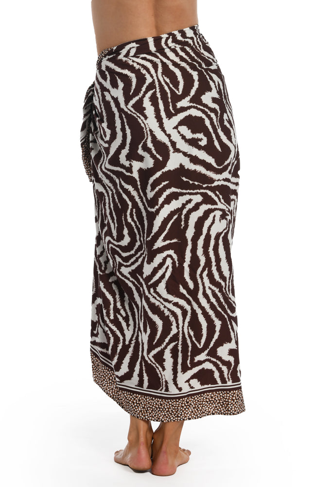 
            
                Load image into Gallery viewer, Model is wearing a java colored animal printed pareo wrap cover up in our Fierce Lines collection!
            
        