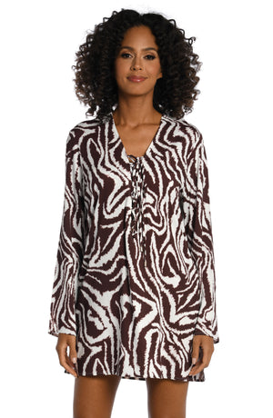 Model is wearing a java colored animal printed v-neck tunic cover up in our Fierce Lines collection!