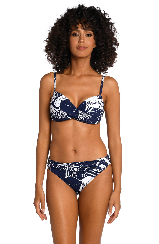 Model is wearing an indigo colored print with pops of white on this over the shoulder top from our At the Playa collection!
