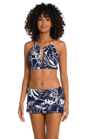 Model is wearing an indigo colored print with pops of white on this high neck midkini top from our At the Playa collection!