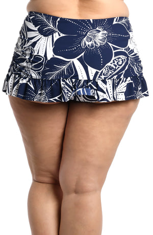 
            
                Load image into Gallery viewer, Model is wearing an indigo colored print with pops of white on this ruffle skirted bottom from our At the Playa collection!
            
        