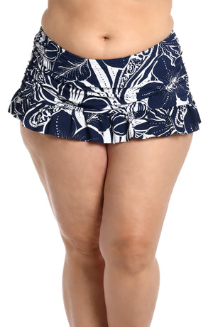 
            
                Load image into Gallery viewer, Model is wearing an indigo colored print with pops of white on this ruffle skirted bottom from our At the Playa collection!
            
        