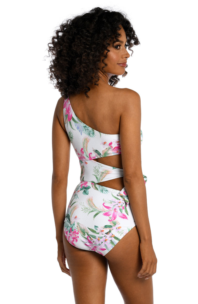 
            
                Load image into Gallery viewer, Model is wearing multi colored tropical print on a white backround with this one shoulder one piece from our Mystic Palms collection!
            
        
