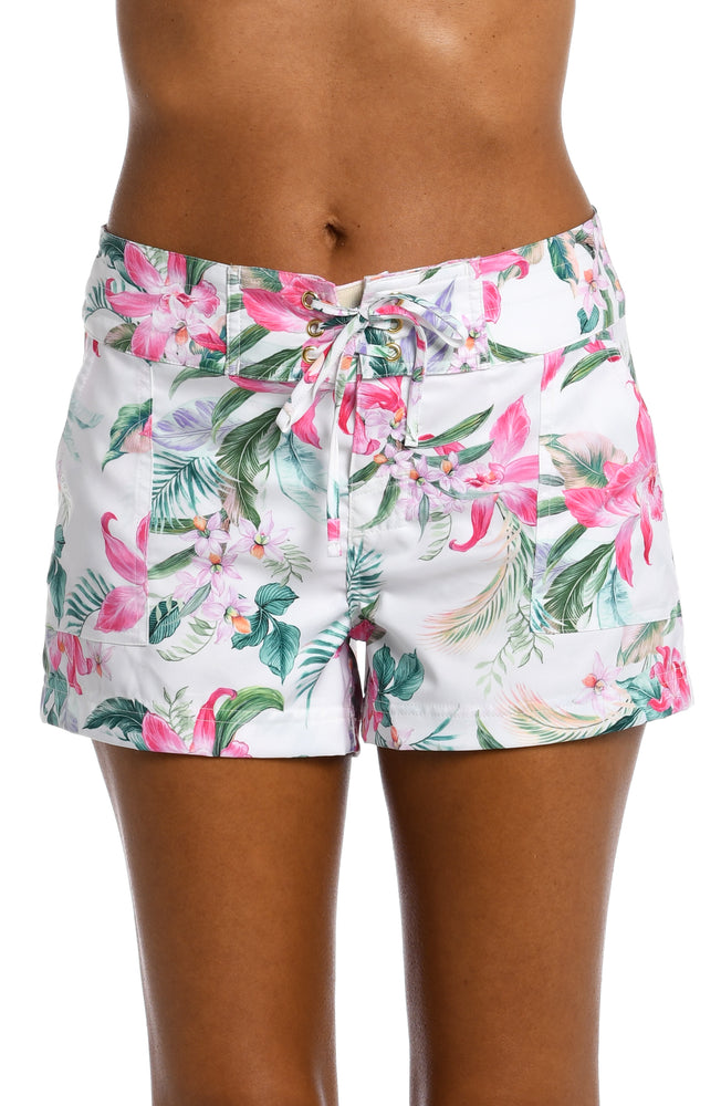 
            
                Load image into Gallery viewer, Model is wearing multi colored tropical print on a white backround with this 3&amp;quot;inseam board short bottom from our Mystic Palms collection!
            
        
