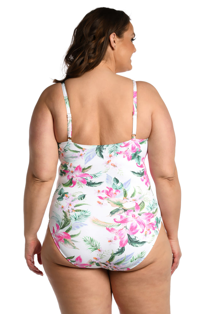 Model is wearing multi colored tropical print on a white backround with this lingerie one piece from our Mystic Palms collection!