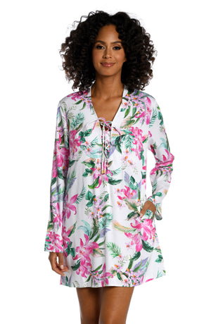 Model is wearing multi colored tropical print on a white backround with this v-neck tunic cover up from our Mystic Palms collection!