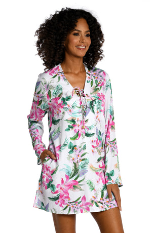 Model is wearing multi colored tropical print on a white backround with this v-neck tunic cover up from our Mystic Palms collection!