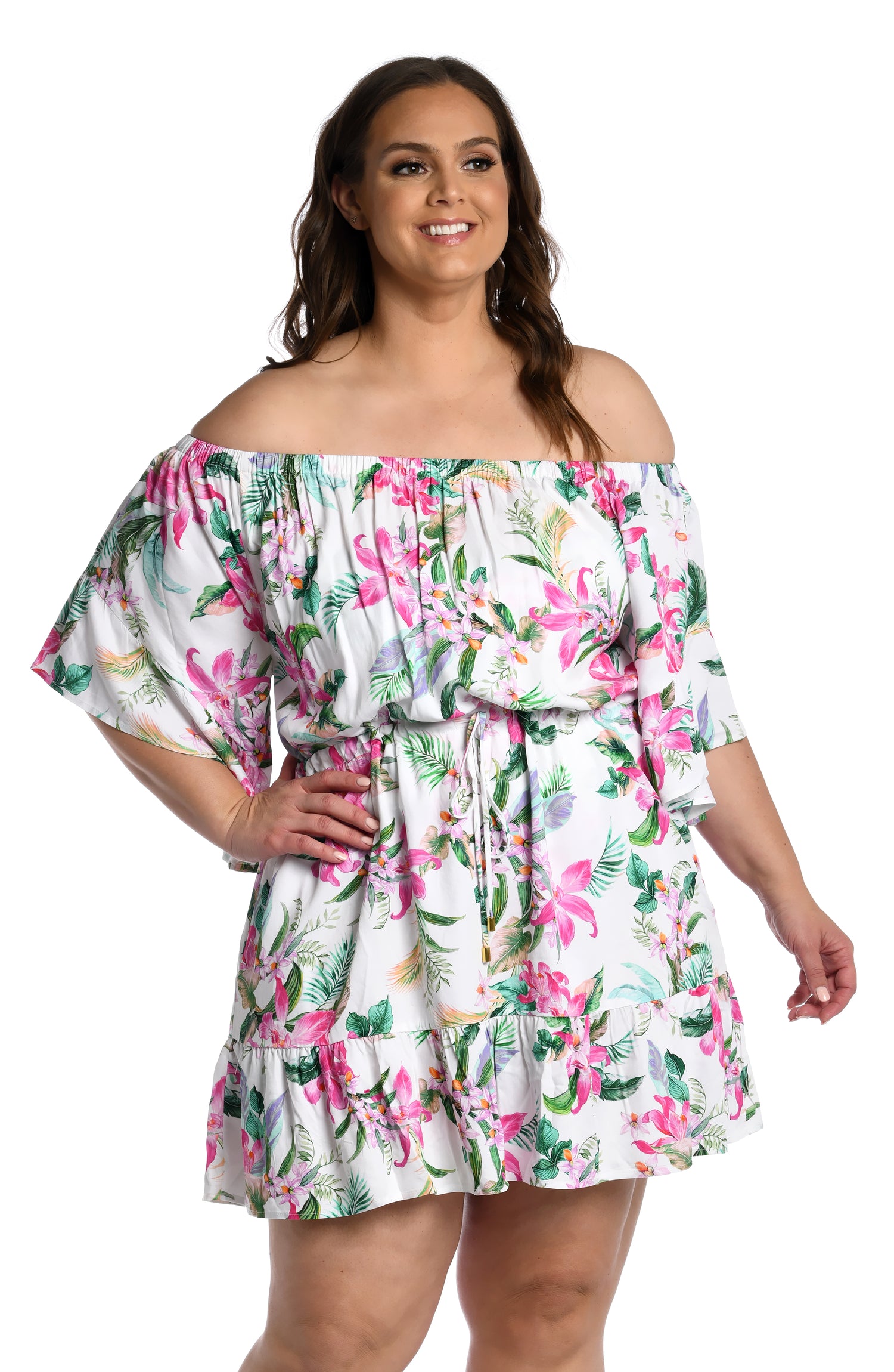 Model is wearing multi colored tropical print on a white backround with this off shoulder cover up dress from our Mystic Palms collection!