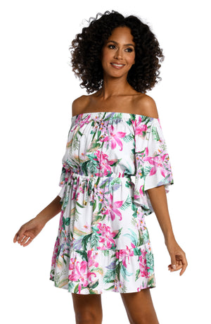 Model is wearing multi colored tropical print on a white backround with this off shoulder cover up dress from our Mystic Palms collection!
