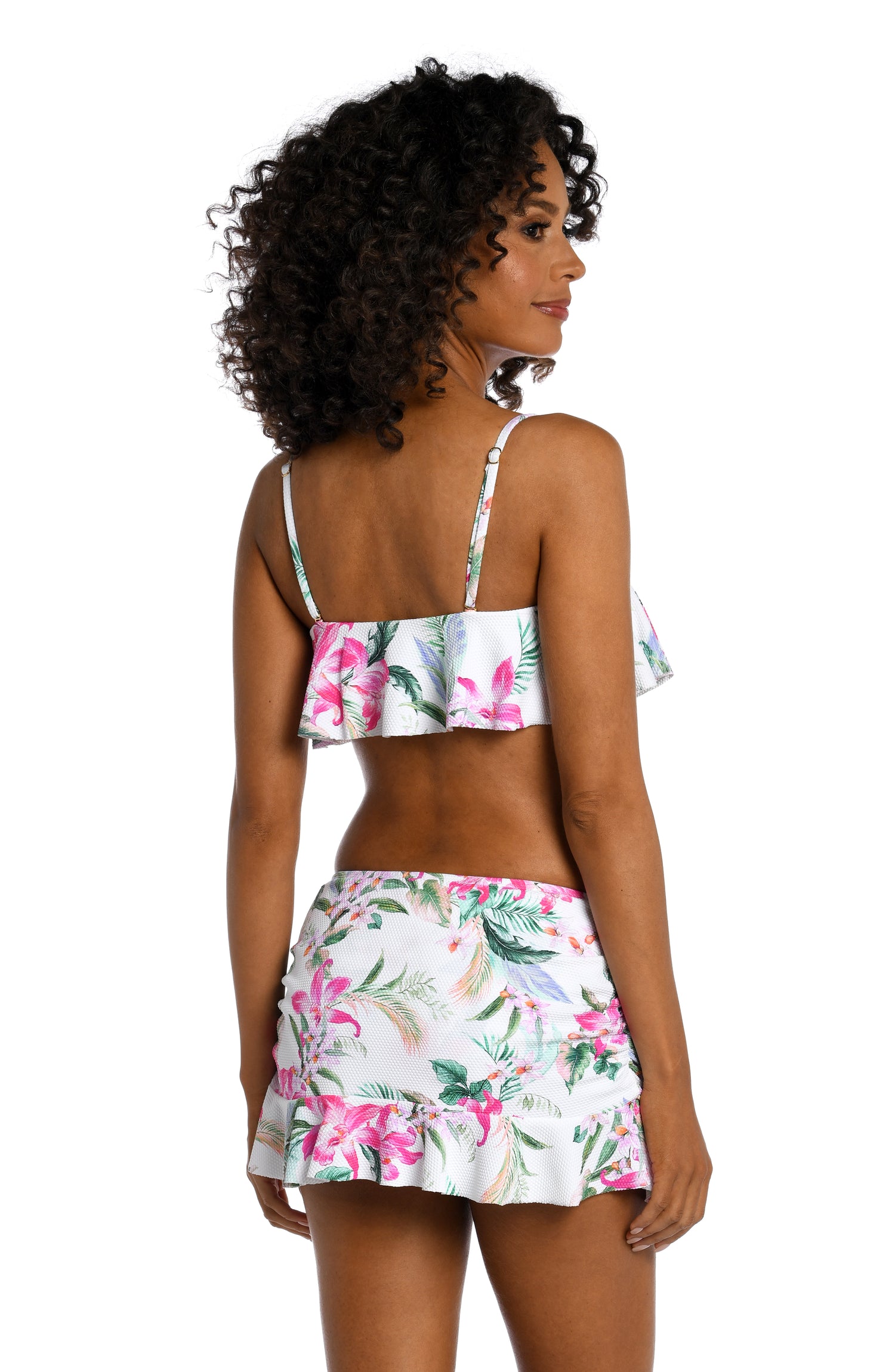 Model is wearing multi colored tropical print on a white backround with this ruffle bandeau top from our Mystic Palms collection!