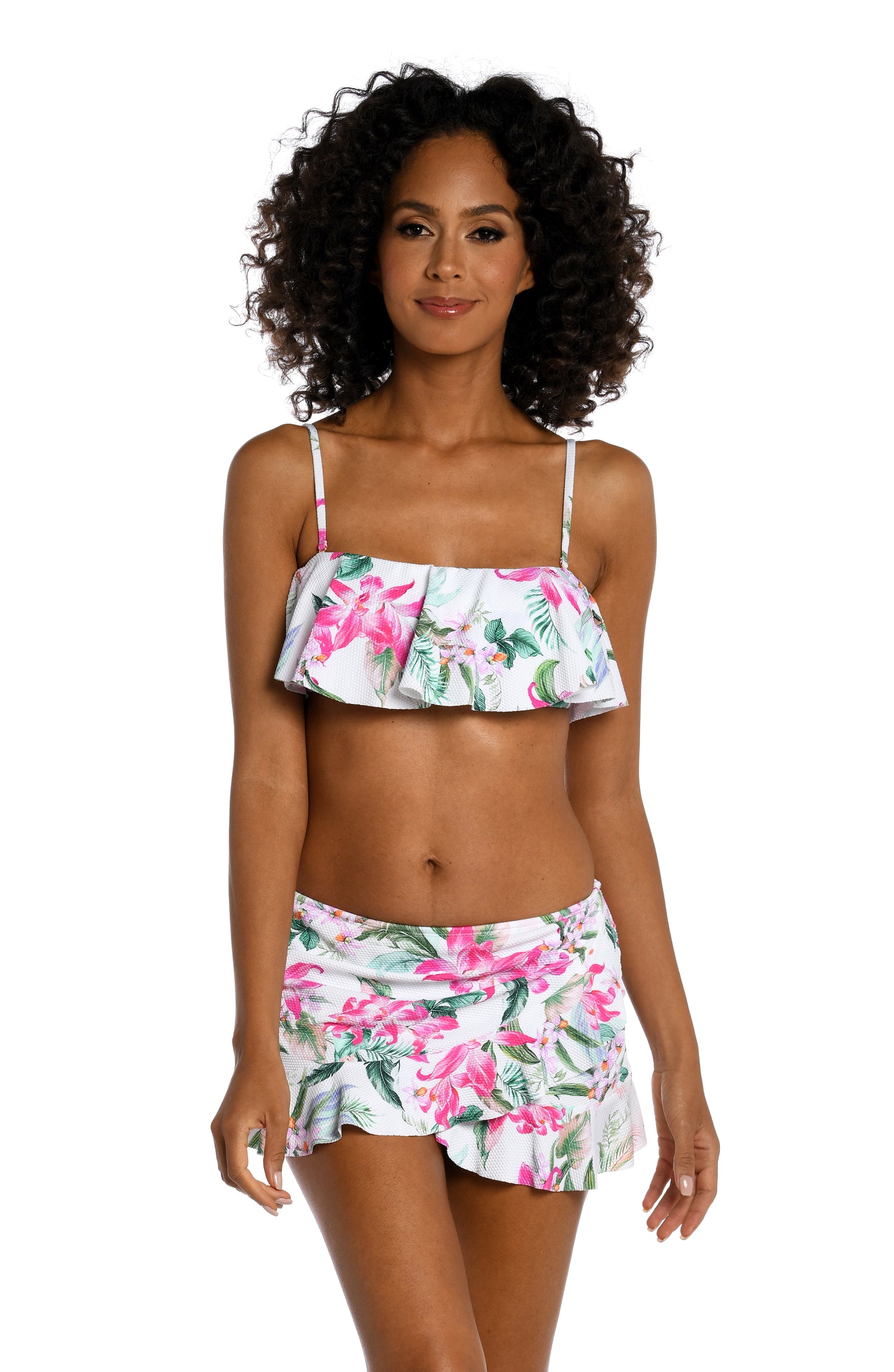Model is wearing multi colored tropical print on a white backround with this ruffle bandeau top from our Mystic Palms collection!