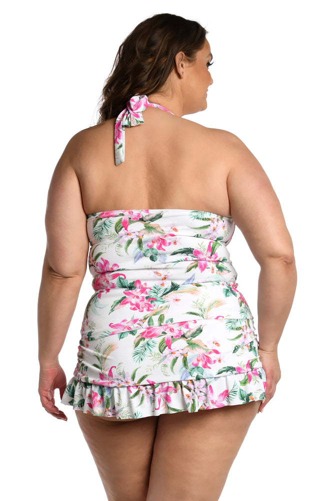 Model is wearing multi colored tropical print on a white backround with this halter tankini top from our Mystic Palms collection!