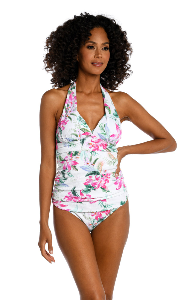 Model is wearing multi colored tropical print on a white backround with this halter tankini top from our Mystic Palms collection!