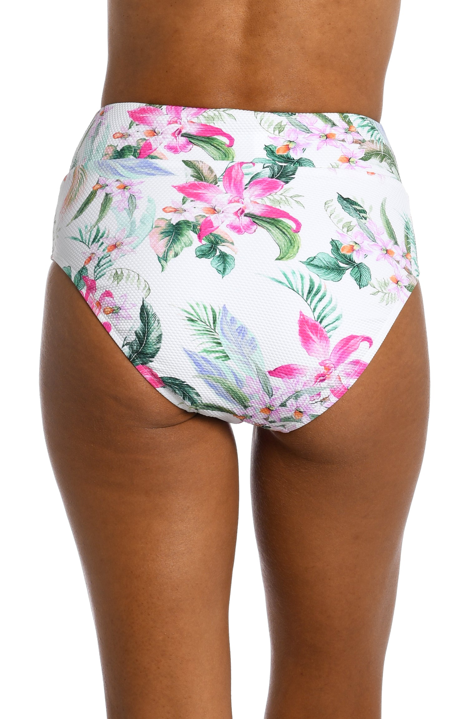 Model is wearing multi colored tropical print on a white backround with this high waist bottom from our Mystic Palms collection!