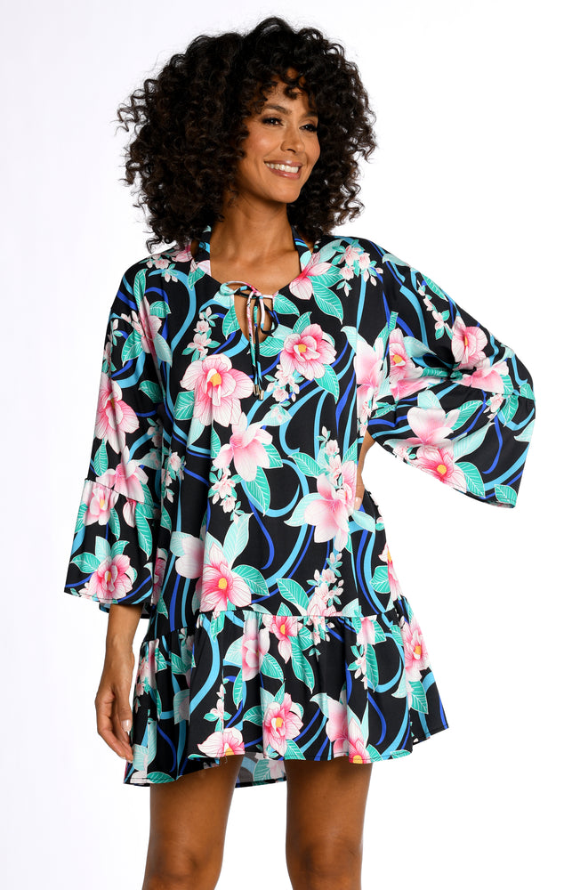Model is wearing pink multi colored tropical foral print on this flounce tunic cover up from our Nightfall Blooms collection!