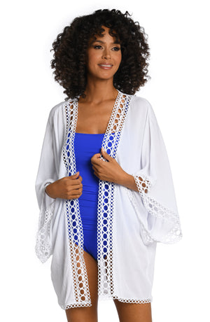 Model is wearing a white colored crochet kimono cover up from our Illusion Covers collection!