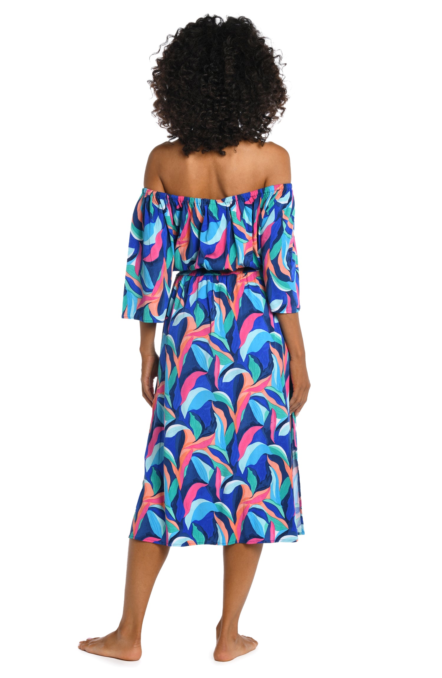 Model is wearing a bold paint-like stroke of vibrant dark colors printed on this off shoulder cover up dress from our Painted Leaves collection!