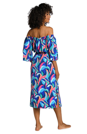 Model is wearing a bold paint-like stroke of vibrant dark colors printed on this off shoulder cover up dress from our Painted Leaves collection!