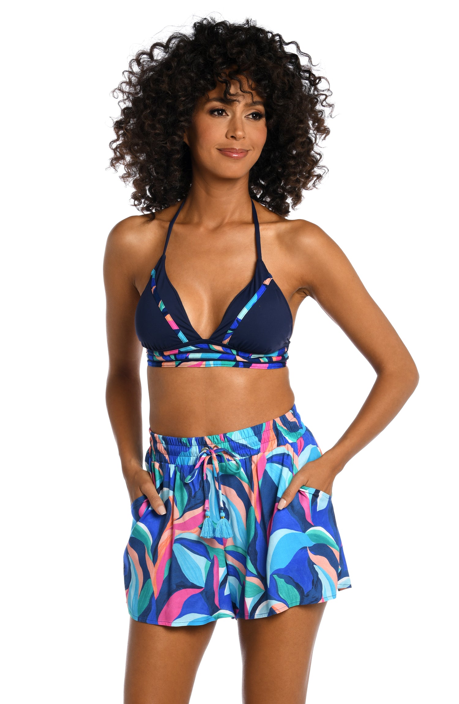 Model is wearing a bold paint-like stroke of vibrant dark colors printed on these beach short bottoms from our Painted Leaves collection!